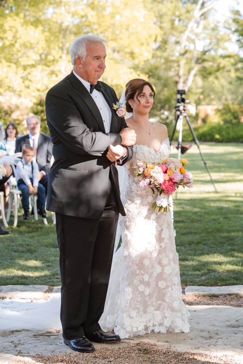 Bride L and groom S posing near Barr Mansion venue entrance