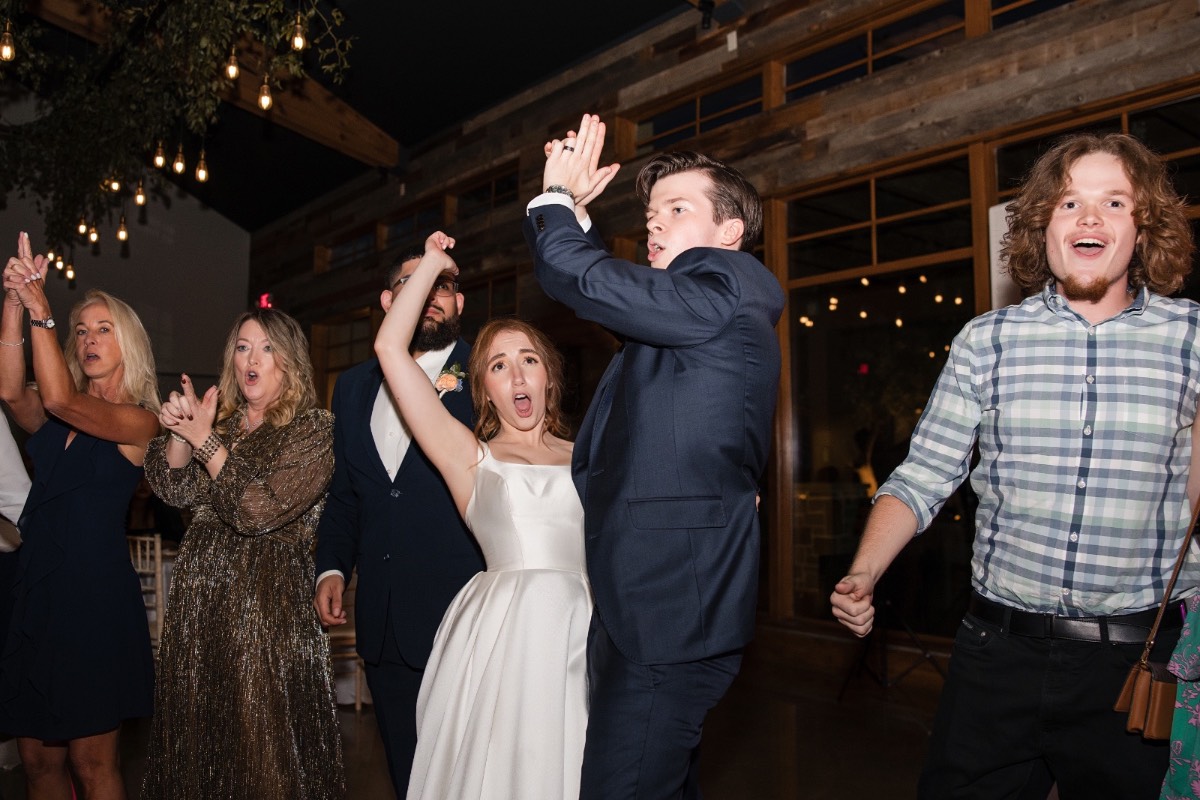 Dancing guests celebrate at Canyonwood Ridge wedding reception in Dripping Springs Texas