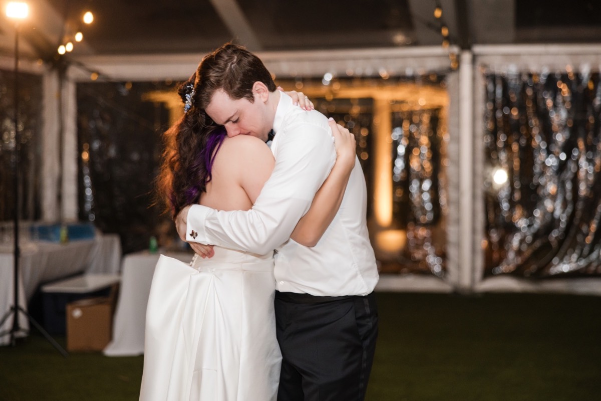 Dancing under lights at Woodbine Mansion wedding reception