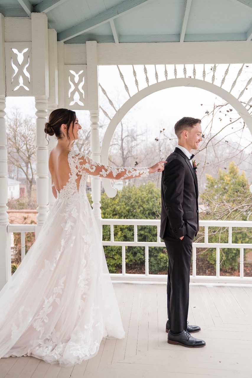Bridesmaids in dresses at rainy Barr Mansion wedding day.