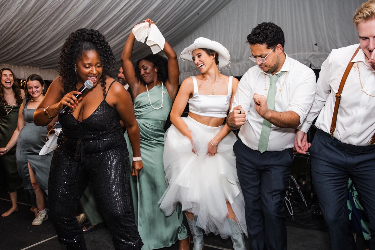Couple surrounded by dancing guests at Balcones Springs wedding reception