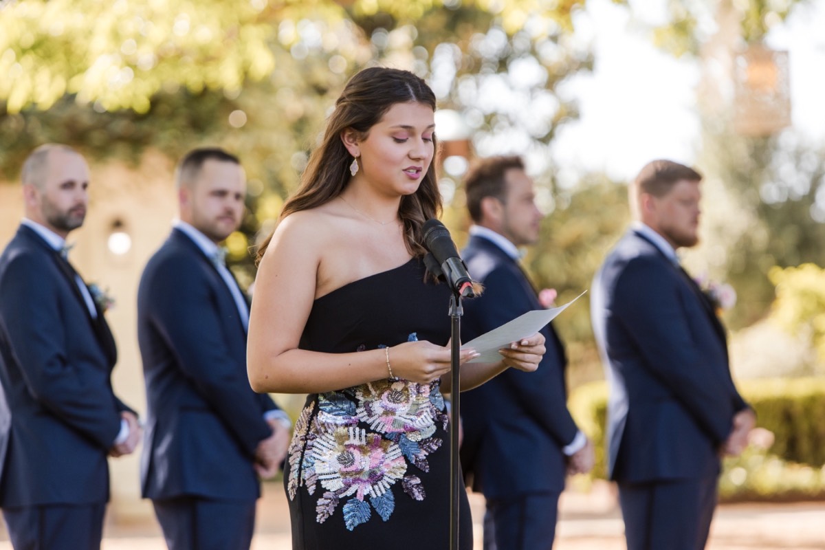 Bride L adjusting groom S's jacket during portrait session at Barr Mansion