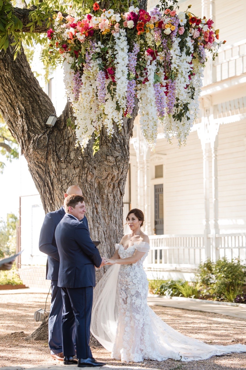 Bride L and groom S walking together at Barr Mansion venue