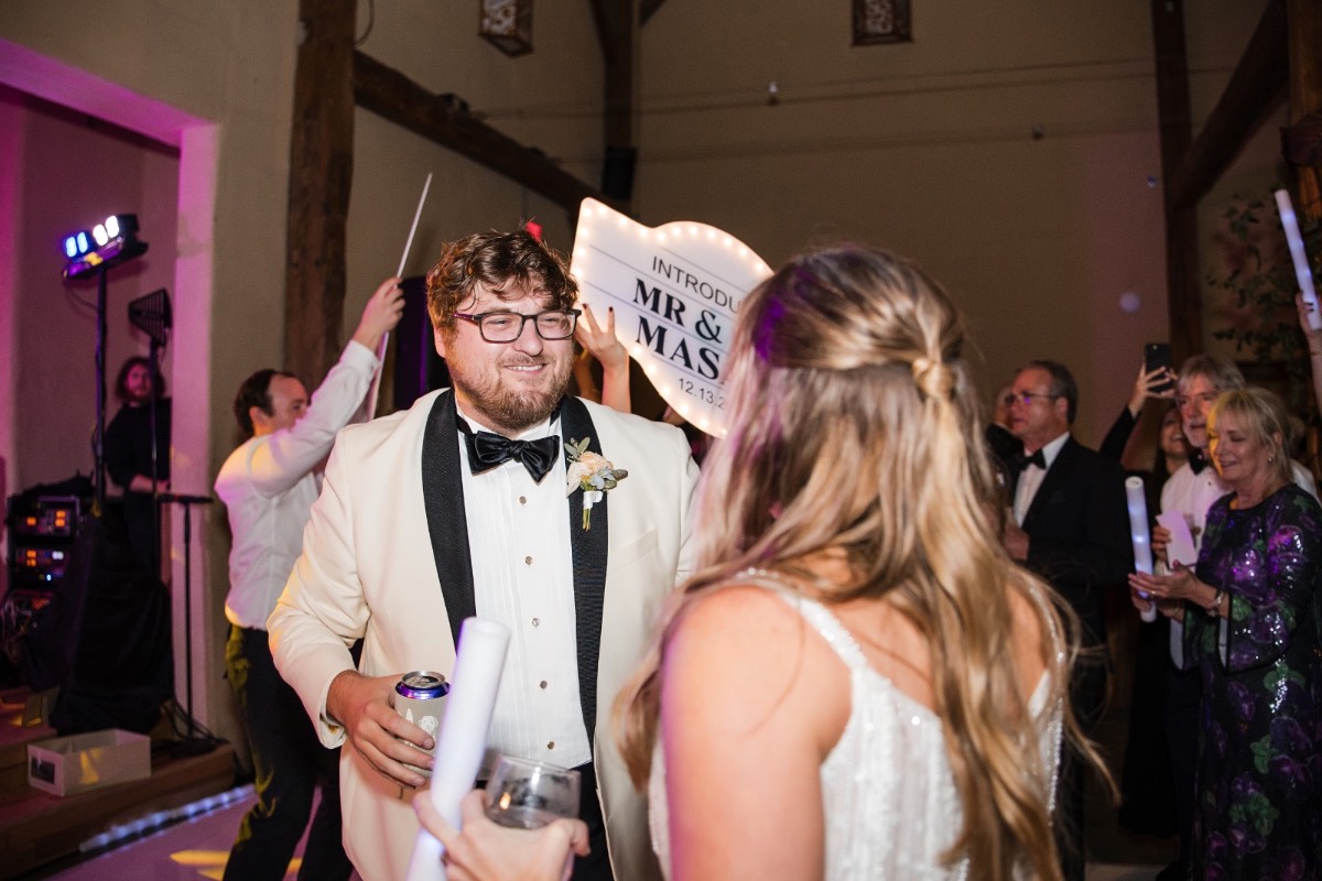 Bride laughing during speech at Barr Mansion winter wedding reception.
