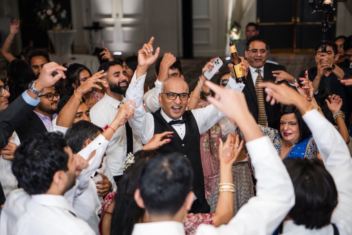 Newlyweds running through sparkler lined path at Renaissance Austin Hotel wedding exit