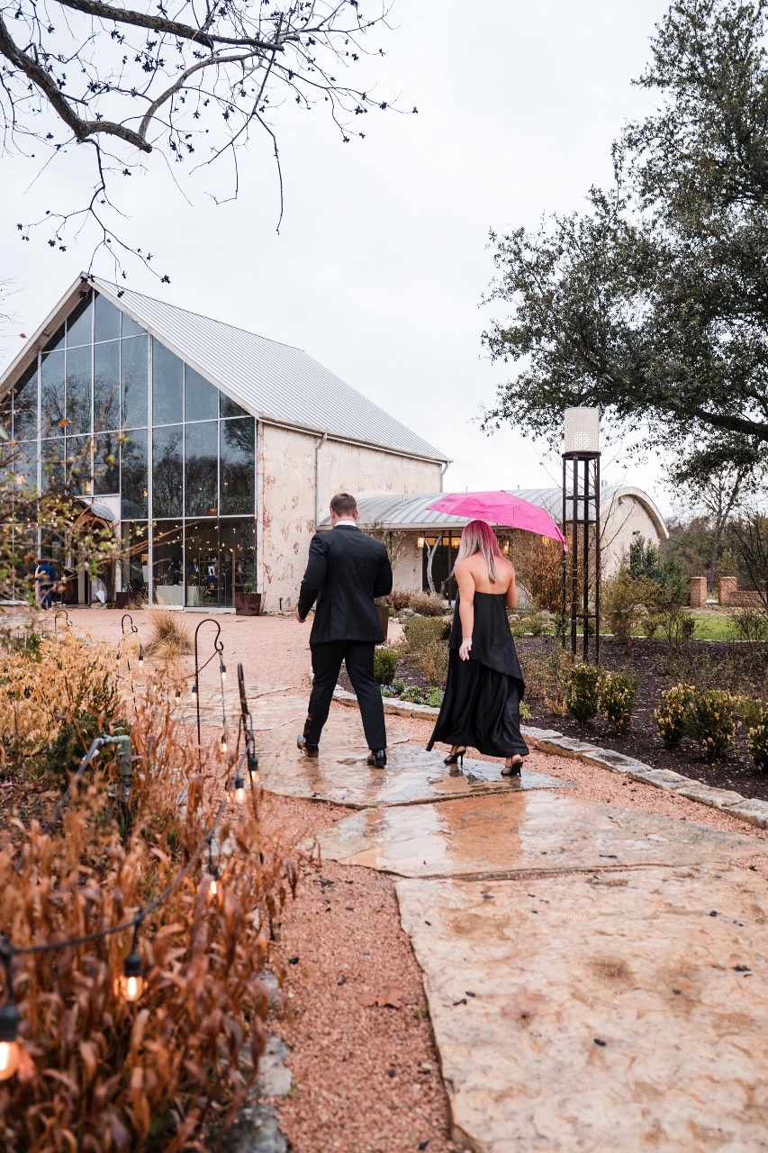 Guests celebrating during reception at rainy Barr Mansion wedding.