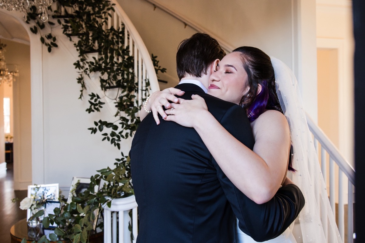 Groom adjusting cufflinks before Woodbine Mansion ceremony in Texas