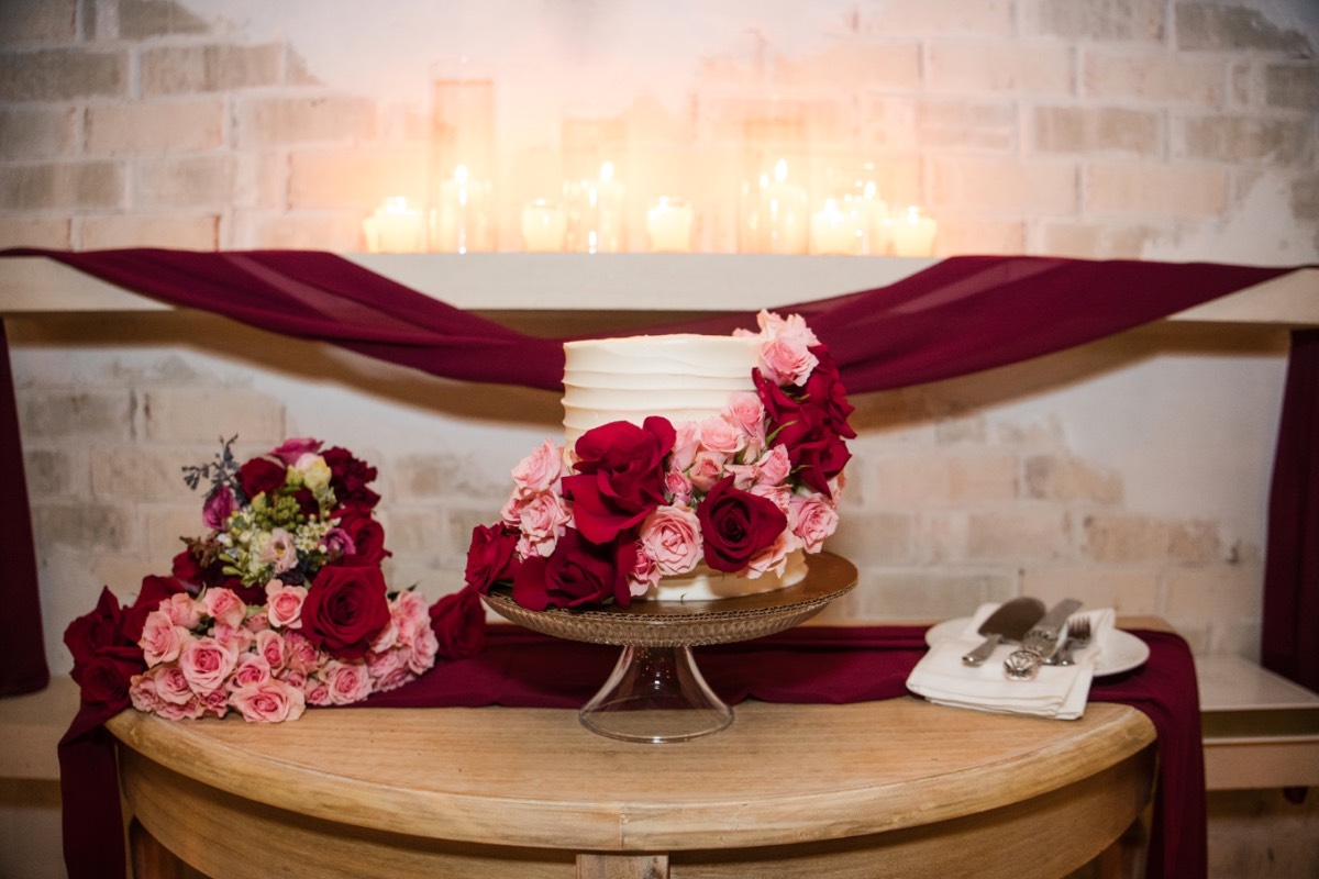 Bride and groom toasting during rainy reception at venue.