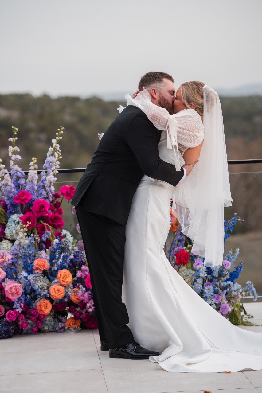 Newlyweds feeding each other cake at The Videre Estate celebration